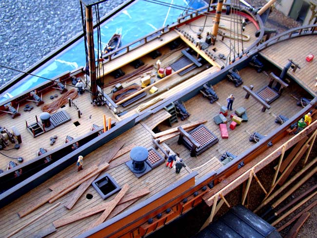 A fabulous and highly detailed scale model diorama circa 1920 of a New England Ship yard circa 1800-1812 making repairs on a 38 Gun American Frigate and a 10 Gun Privateer built circa 1785. — image 7
